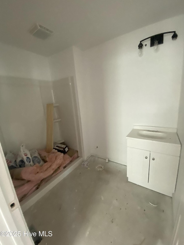 bathroom featuring a shower and concrete floors