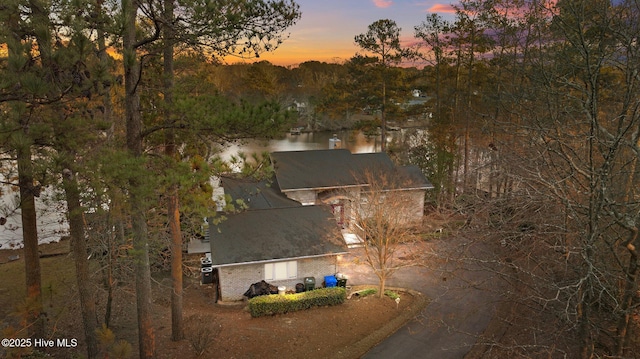 aerial view at dusk with a water view