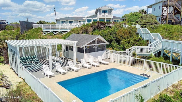 back of house featuring a pergola, a sunroom, a patio, and a fenced in pool