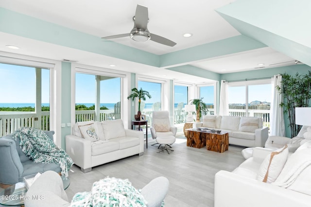 sunroom featuring ceiling fan and a wealth of natural light