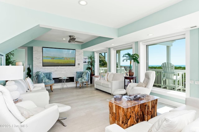 living room featuring light hardwood / wood-style flooring and ceiling fan