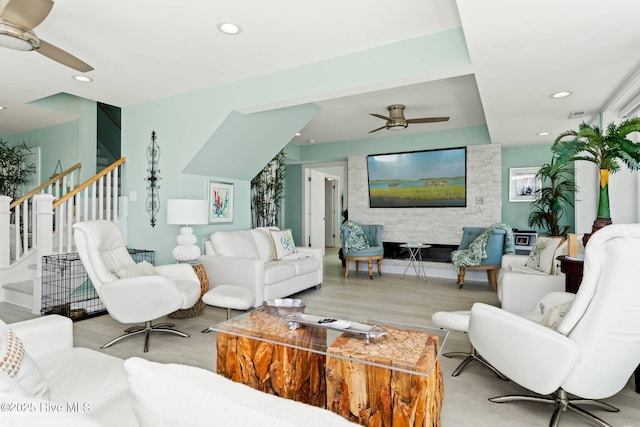 living room featuring light hardwood / wood-style flooring and ceiling fan