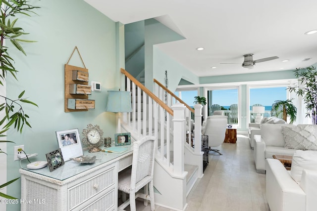 stairs featuring hardwood / wood-style flooring and ceiling fan