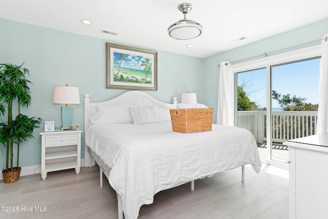 bedroom featuring access to exterior and light hardwood / wood-style flooring