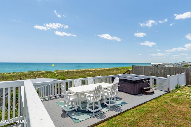 wooden deck featuring a view of the beach, a water view, and a hot tub