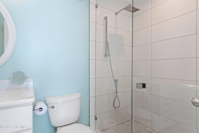 bathroom featuring vanity, toilet, and an enclosed shower