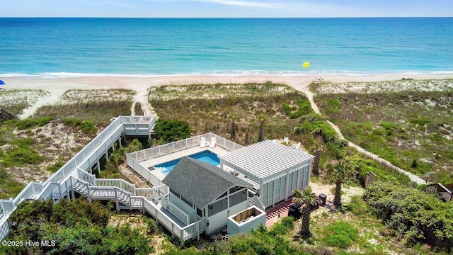 drone / aerial view with a water view and a view of the beach