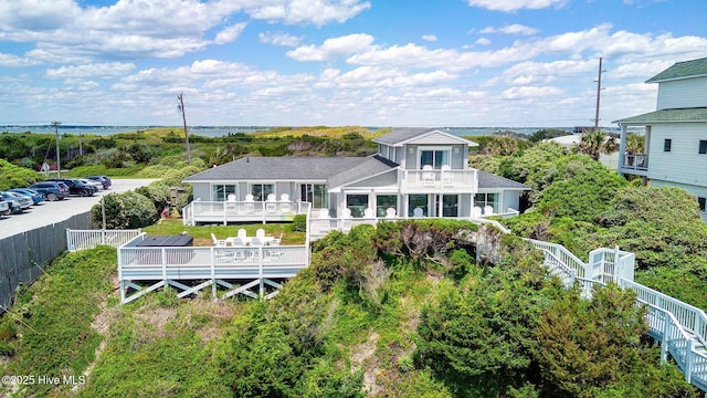 back of property with a balcony and a wooden deck