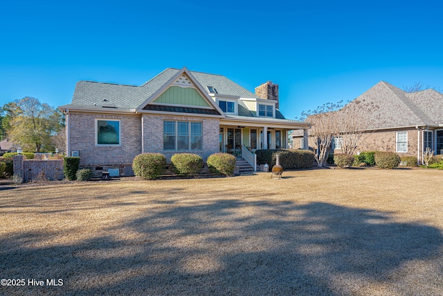 view of front of property with covered porch and a front lawn