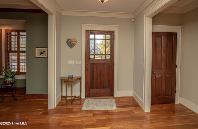 entryway featuring crown molding and hardwood / wood-style flooring