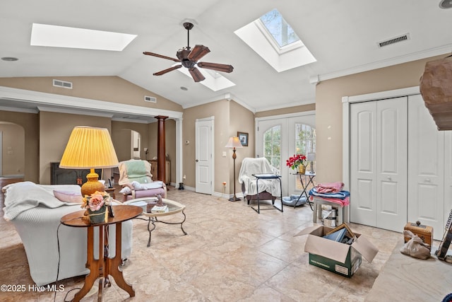 living room featuring vaulted ceiling, ceiling fan, ornamental molding, and french doors