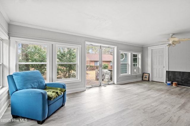 sunroom / solarium featuring ceiling fan