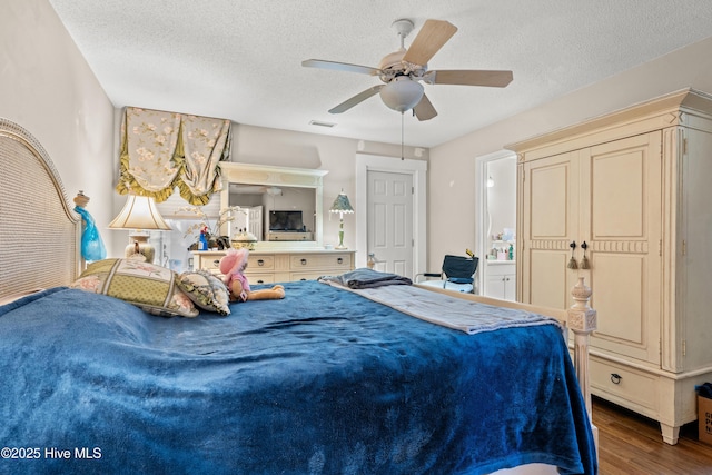 bedroom featuring ceiling fan, hardwood / wood-style floors, and a textured ceiling