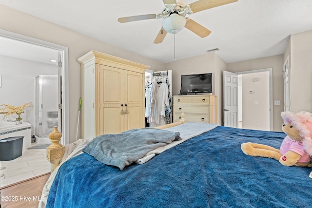 bedroom featuring ceiling fan, a closet, and light wood-type flooring