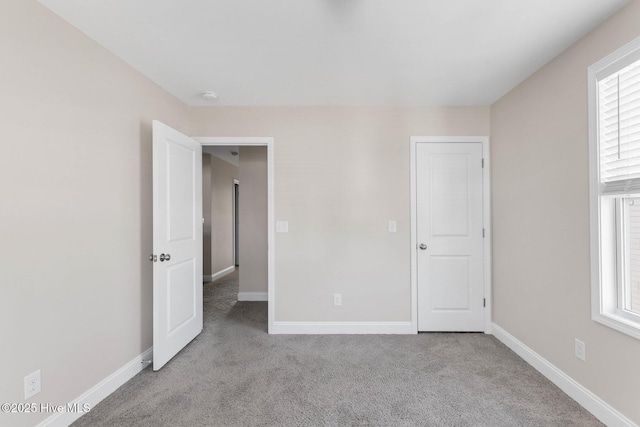 unfurnished bedroom with light colored carpet