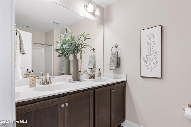 bathroom with vanity and a shower