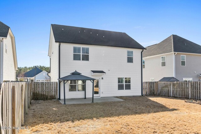 back of house featuring a gazebo, a yard, and a patio area