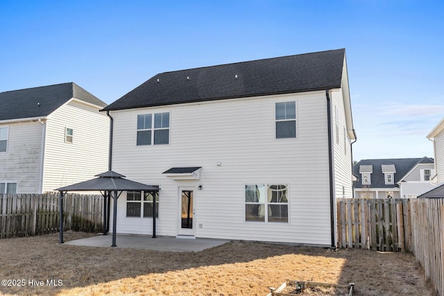 rear view of property featuring a gazebo and a patio area