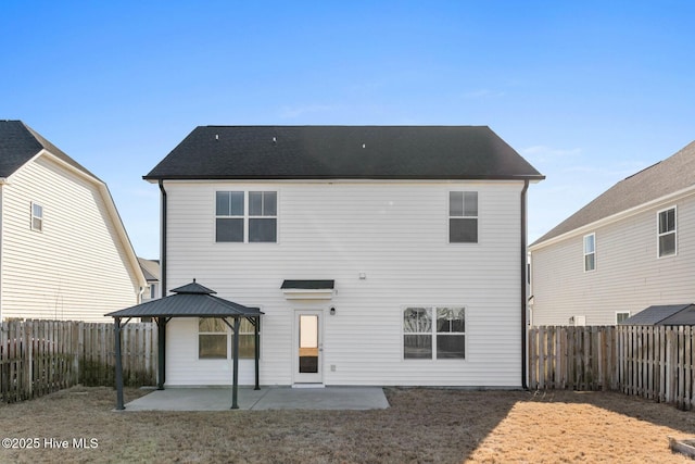 back of property with a gazebo and a patio area