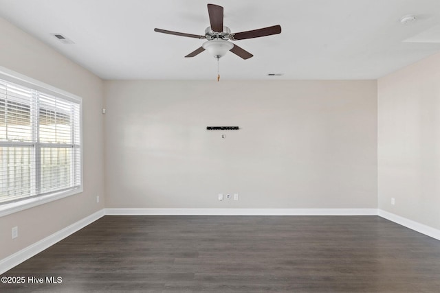 empty room featuring dark wood-type flooring and ceiling fan