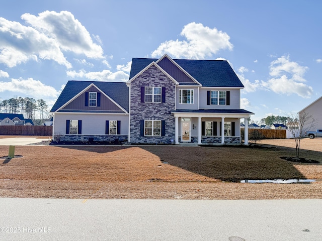 view of front of home featuring covered porch and a front lawn