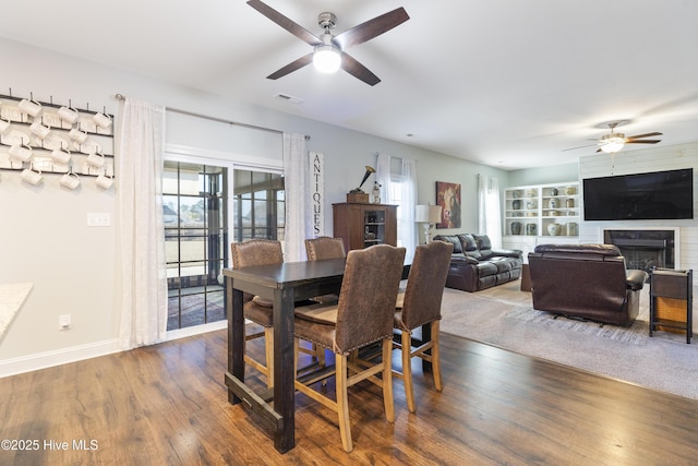 dining room featuring dark hardwood / wood-style flooring and ceiling fan