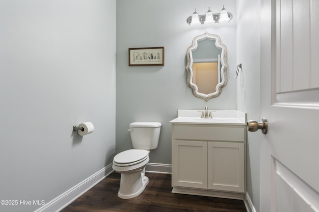 bathroom featuring vanity, wood-type flooring, and toilet