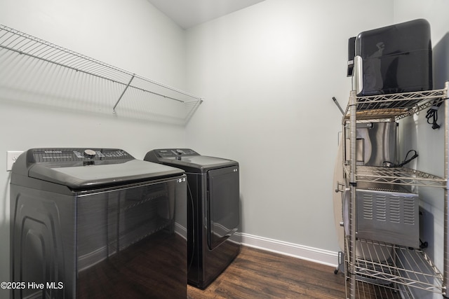 clothes washing area featuring dark hardwood / wood-style flooring and separate washer and dryer