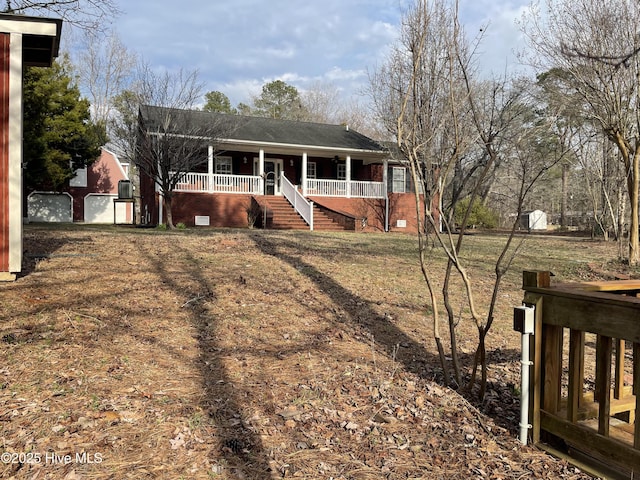 single story home featuring covered porch and stairway