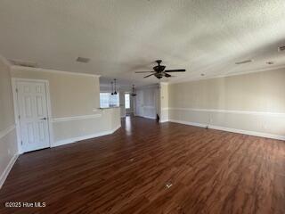 unfurnished living room with a textured ceiling, dark wood finished floors, a ceiling fan, and baseboards