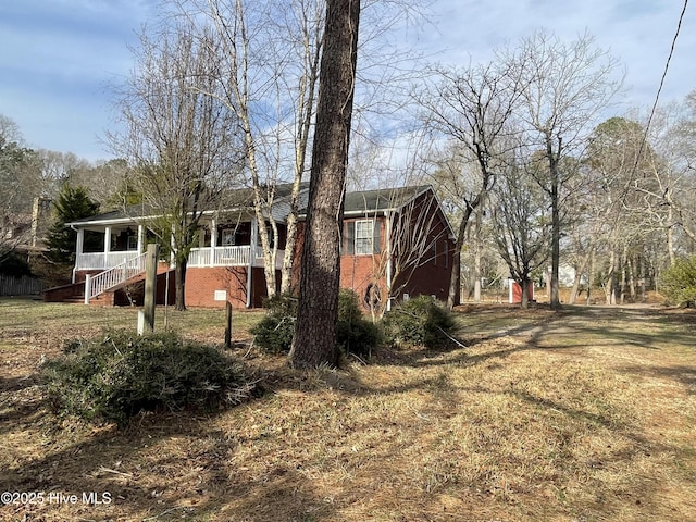 view of side of property with stairway