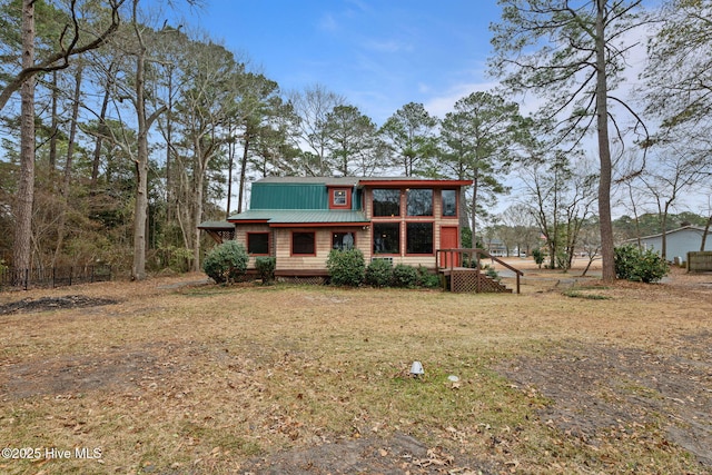 view of front of home featuring a front yard and metal roof