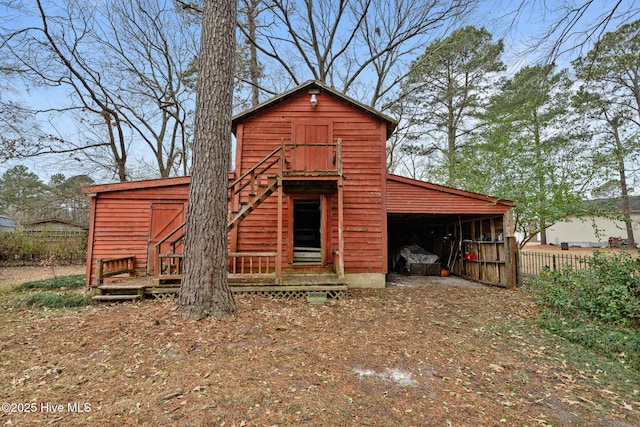view of barn featuring fence