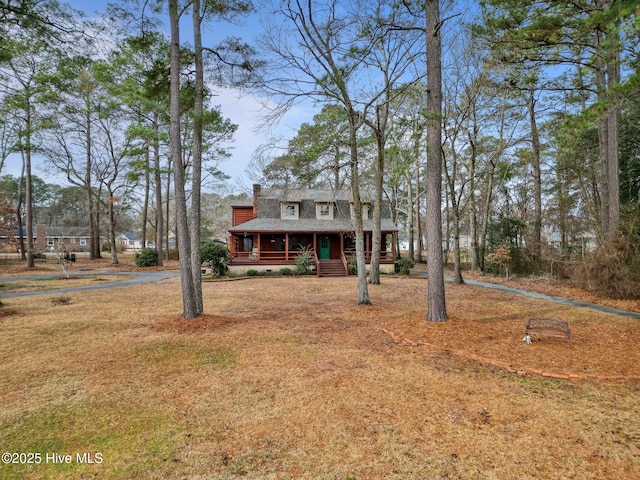 view of front of home with a front yard and covered porch