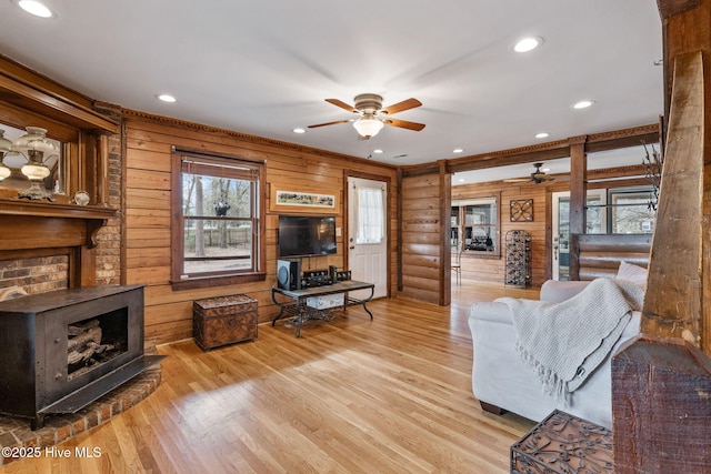 living area with ceiling fan, recessed lighting, wood finished floors, and plenty of natural light