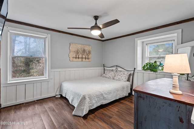 bedroom featuring ornamental molding, dark hardwood / wood-style floors, and ceiling fan