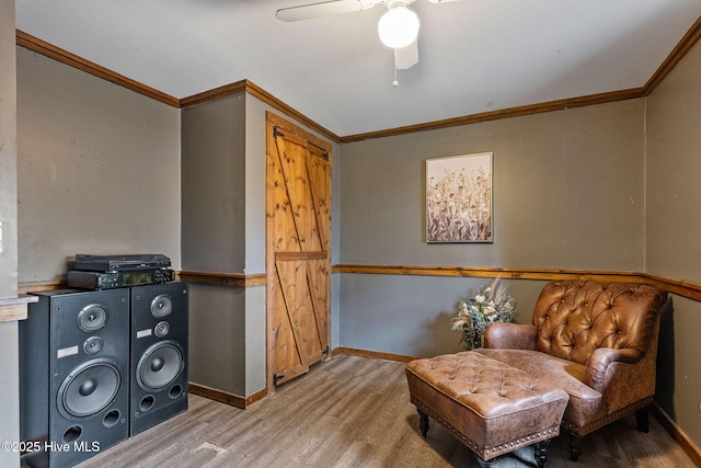 sitting room featuring crown molding, hardwood / wood-style floors, and ceiling fan