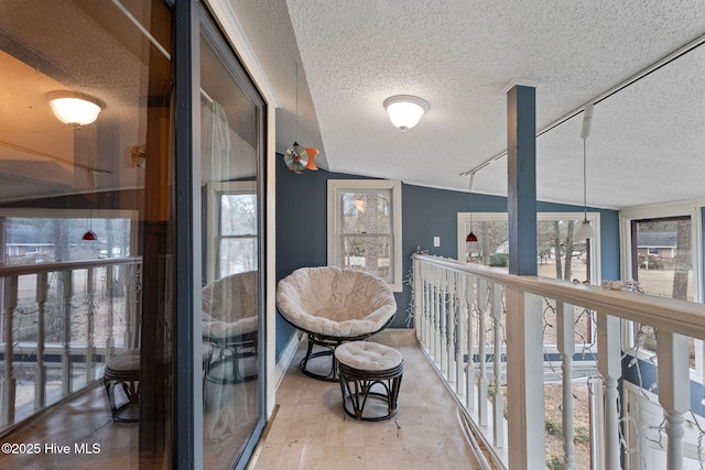 hall featuring a textured ceiling and baseboards