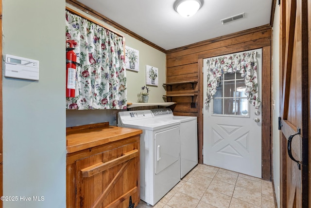 laundry area featuring visible vents, wood walls, independent washer and dryer, laundry area, and ornamental molding