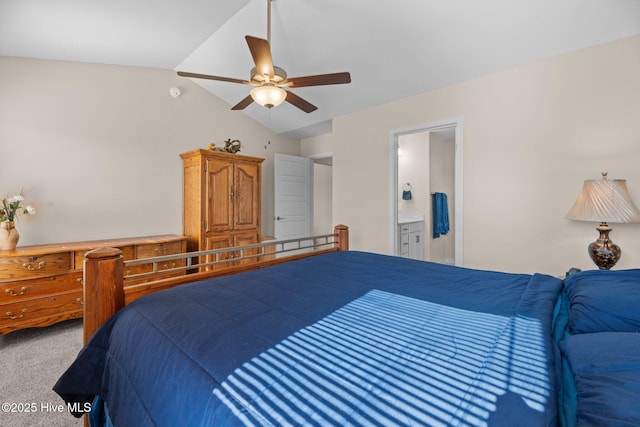 bedroom with vaulted ceiling, ceiling fan, connected bathroom, and carpet floors