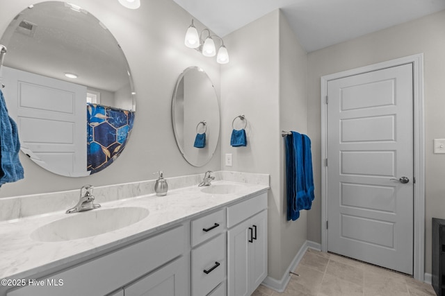 bathroom with vanity and tile patterned flooring