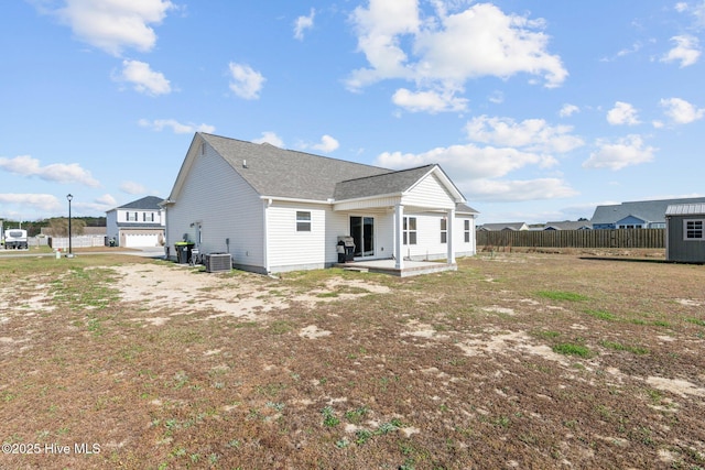 rear view of house featuring central AC, a patio, and a garage