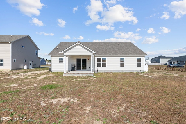 rear view of property featuring a yard and a patio