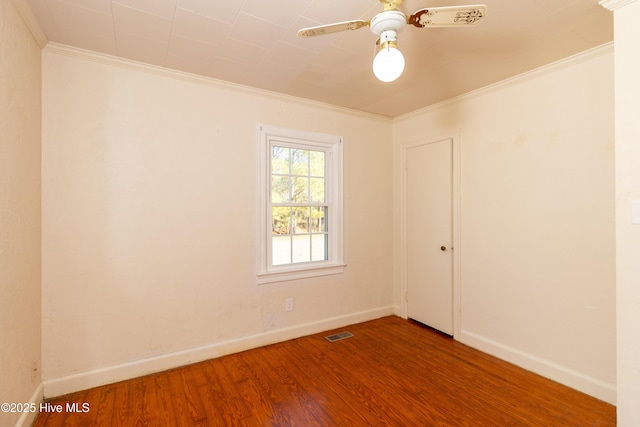 empty room with wood-type flooring, ceiling fan, and ornamental molding