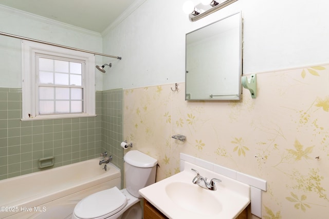 full bathroom featuring tiled shower / bath, toilet, vanity, and ornamental molding