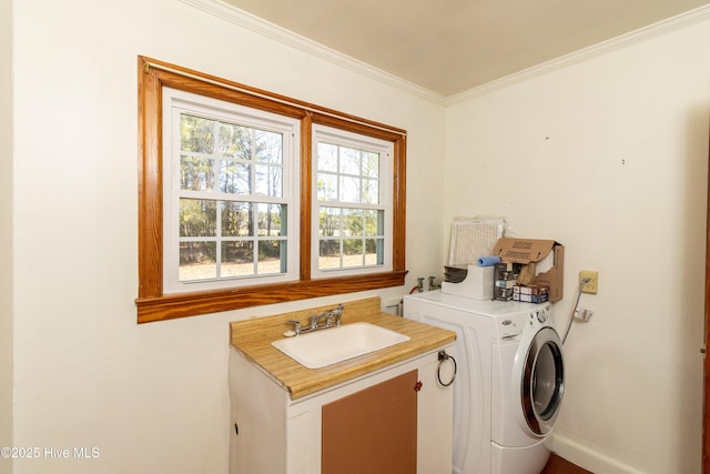 clothes washing area featuring crown molding, sink, and washer / clothes dryer