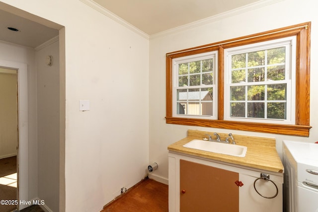 bathroom featuring washer / clothes dryer, crown molding, and vanity