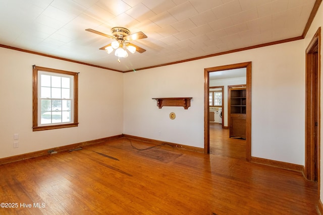 spare room with ceiling fan, wood-type flooring, and ornamental molding