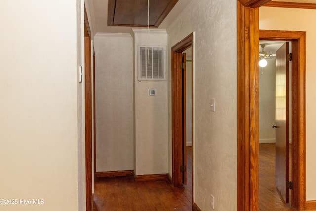 corridor with hardwood / wood-style flooring and ornamental molding