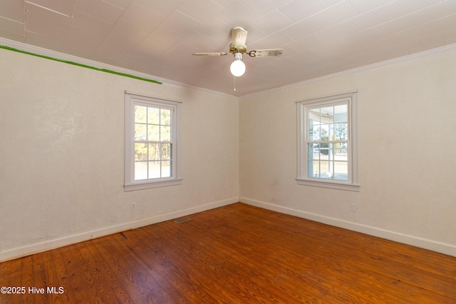 unfurnished room featuring ceiling fan, wood-type flooring, and ornamental molding